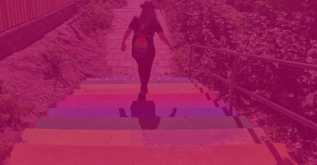 bli medlem webbplats En person går ned för en regnbågsfärgad trappa